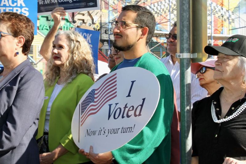 Person holding I Voted sign in Austin