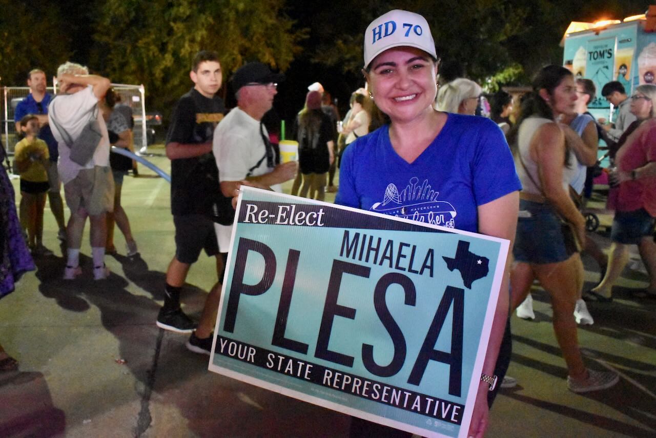 Mihaela Plesa holds campaign sign