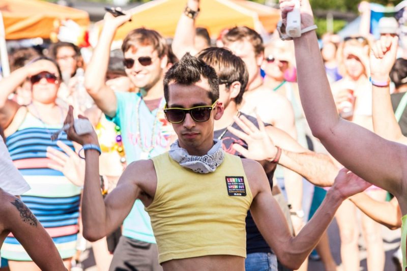 Man in yellow dancing at Houston pride event