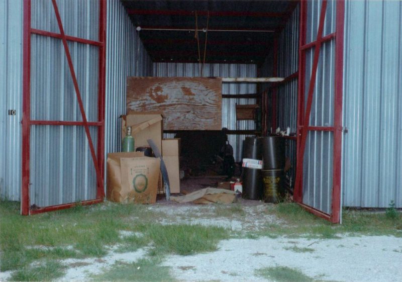 a gray and red boat shed