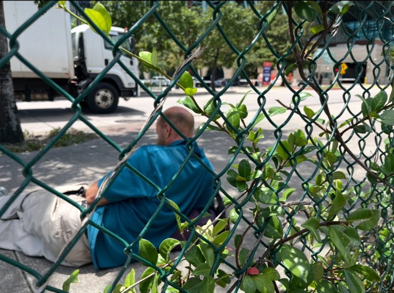Man laying on Houston sidewalk