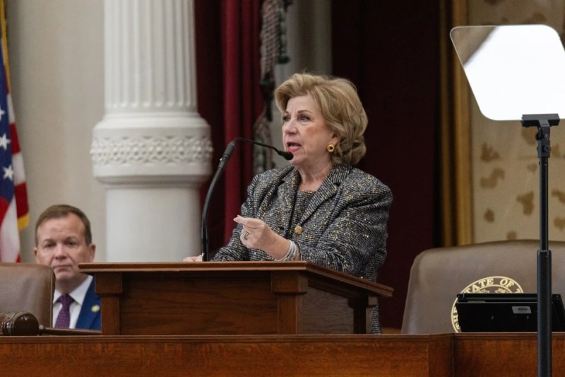 Texas Secretary of State Jane Nelson speaking at a podium