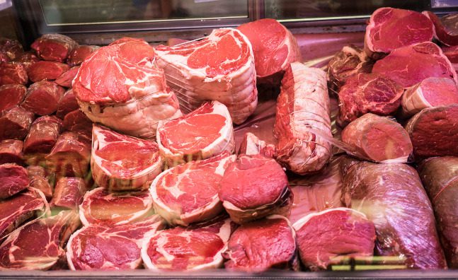 A butcher shop case filled with assorted fresh-cut meats