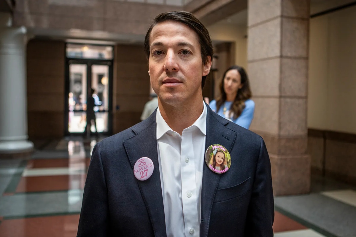 Davin Hunt, father of 9-year-old Janie Hunt, a Camp Mystic camper who died in the flood, during a pause in the committee hearing on Thursday, wearing pins in honor of their loved ones