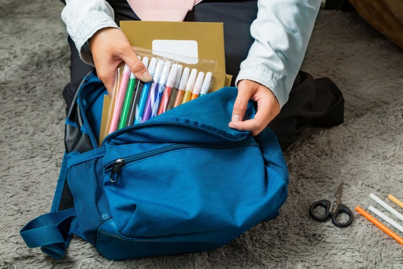 A kid packs supplies that were bought on tax-free weekend in Texas