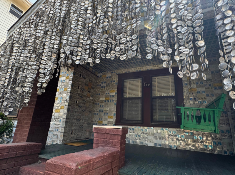 The tops of thousands of beer cans affixed to the house.