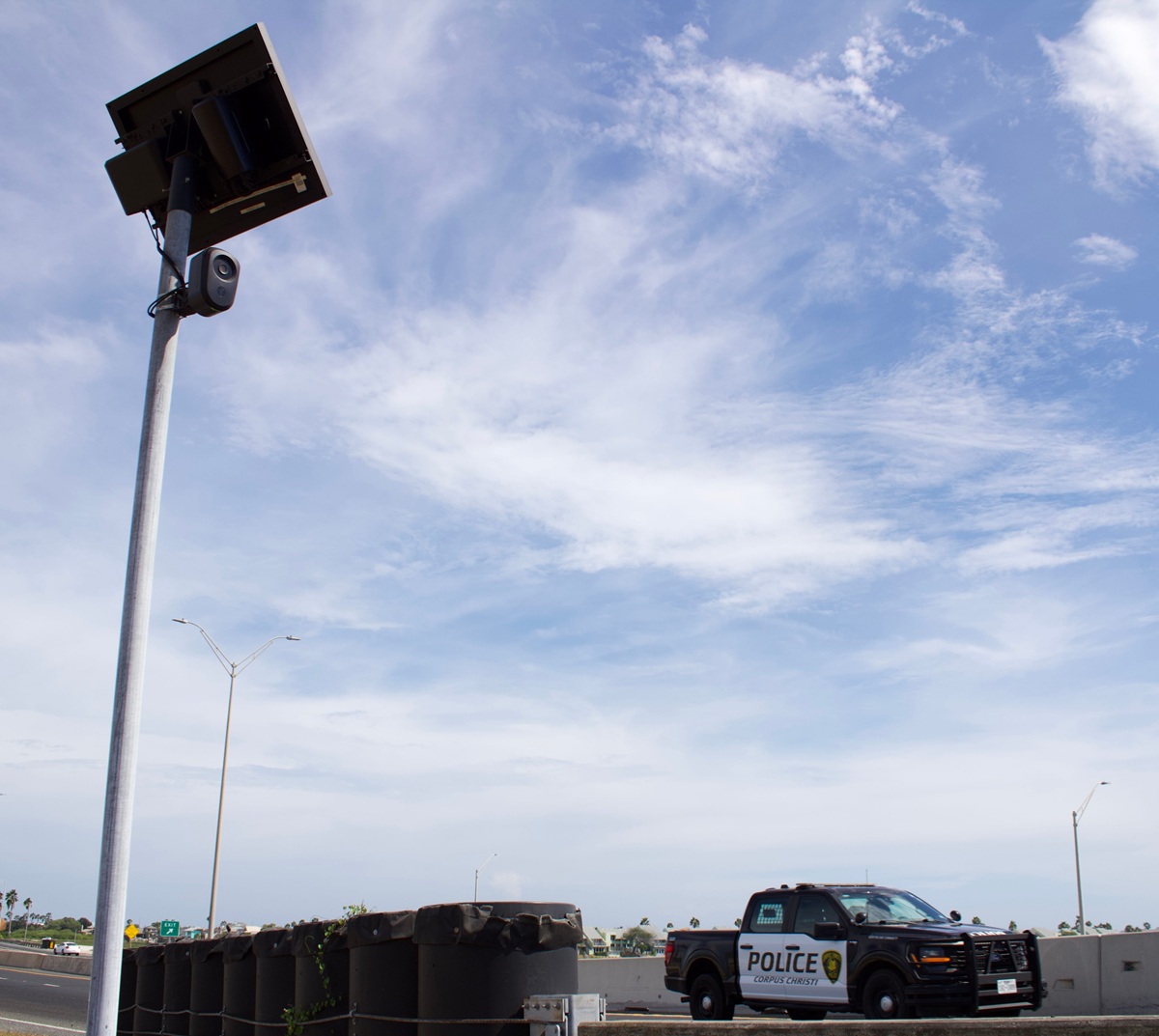 A Flock camera in front of a blue sky
