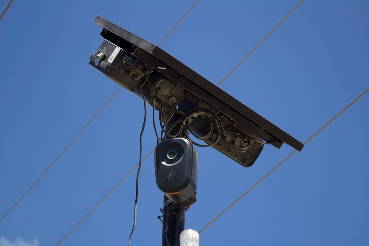 A Flock camera in front of a blue sky