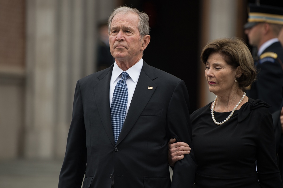 George W. Bush attends a funeral with his wife, Laura Bush