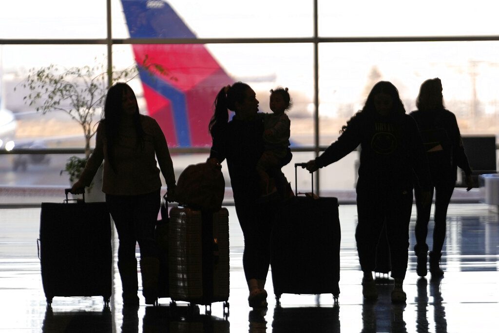 People pass through Salt Lake City International Airport, Wednesday, Jan. 11, 2023, in Salt Lake City. Thousands of travelers were stranded at U.S. airports due to an hours-long computer outage. If a flight is canceled, experts say most airlines will rebook you on the next available flight. But if you choose to cancel the trip, airlines must provide you with a full refund. (AP Photo/Rick Bowmer)