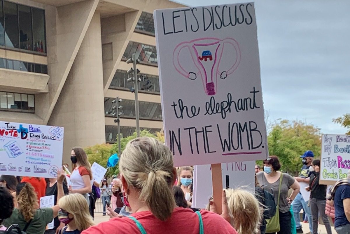 Women holds sign about reproductive rights