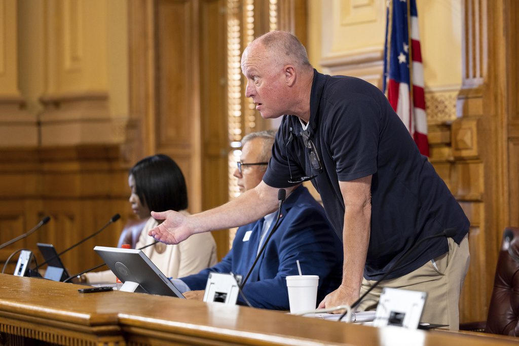 State Election Board member Rick Jeffares asks the crowd to settle down during a hastily planned State Election Board meeting at the Capitol in Atlanta, July 12, 2024. (Arvin Temkar/Atlanta Journal-Constitution via AP, File)