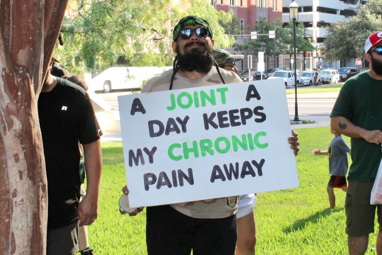 Man holding sign at 11th Annual Texas Marijuana March and Freedom Festival