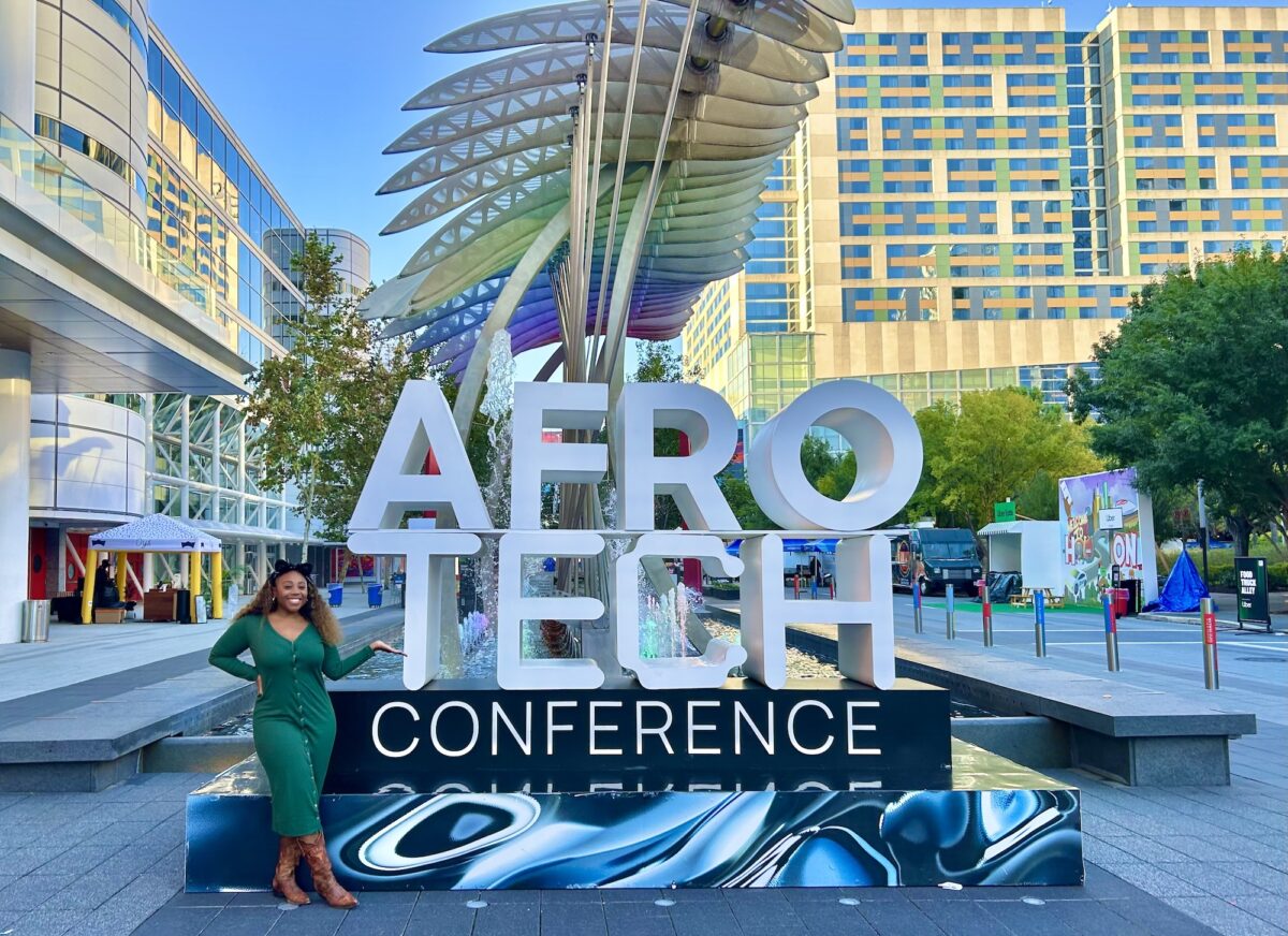Woman standing in front of sign
